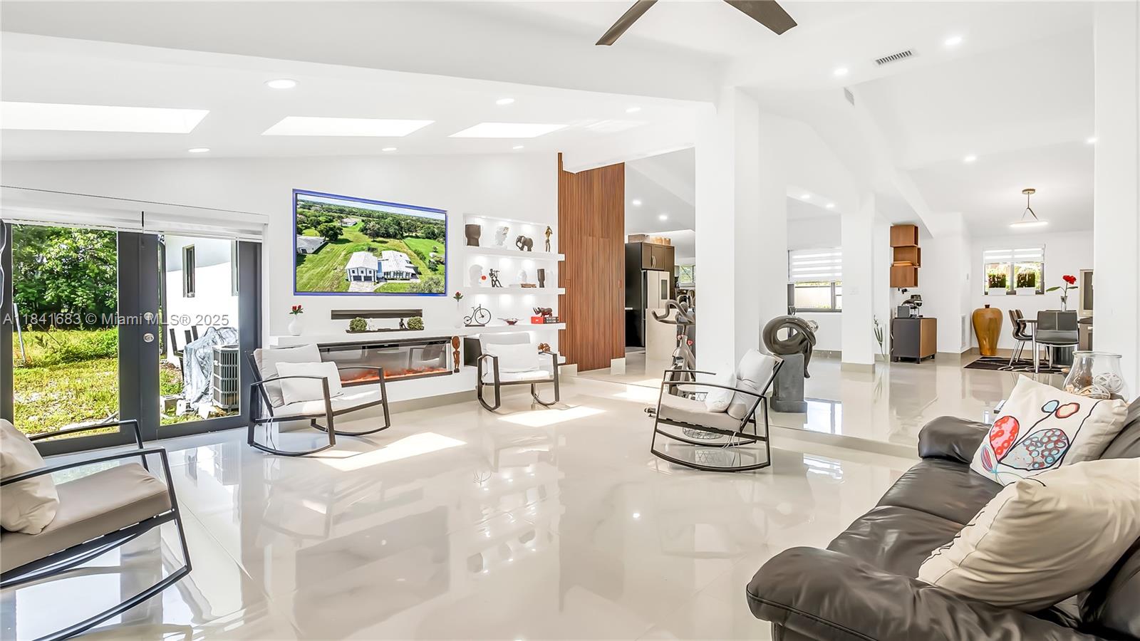 17101 Southwest 48th Street Southwest Ranches, FL 33331 - Photo 32 of 40 a living room with furniture and a flat screen tv