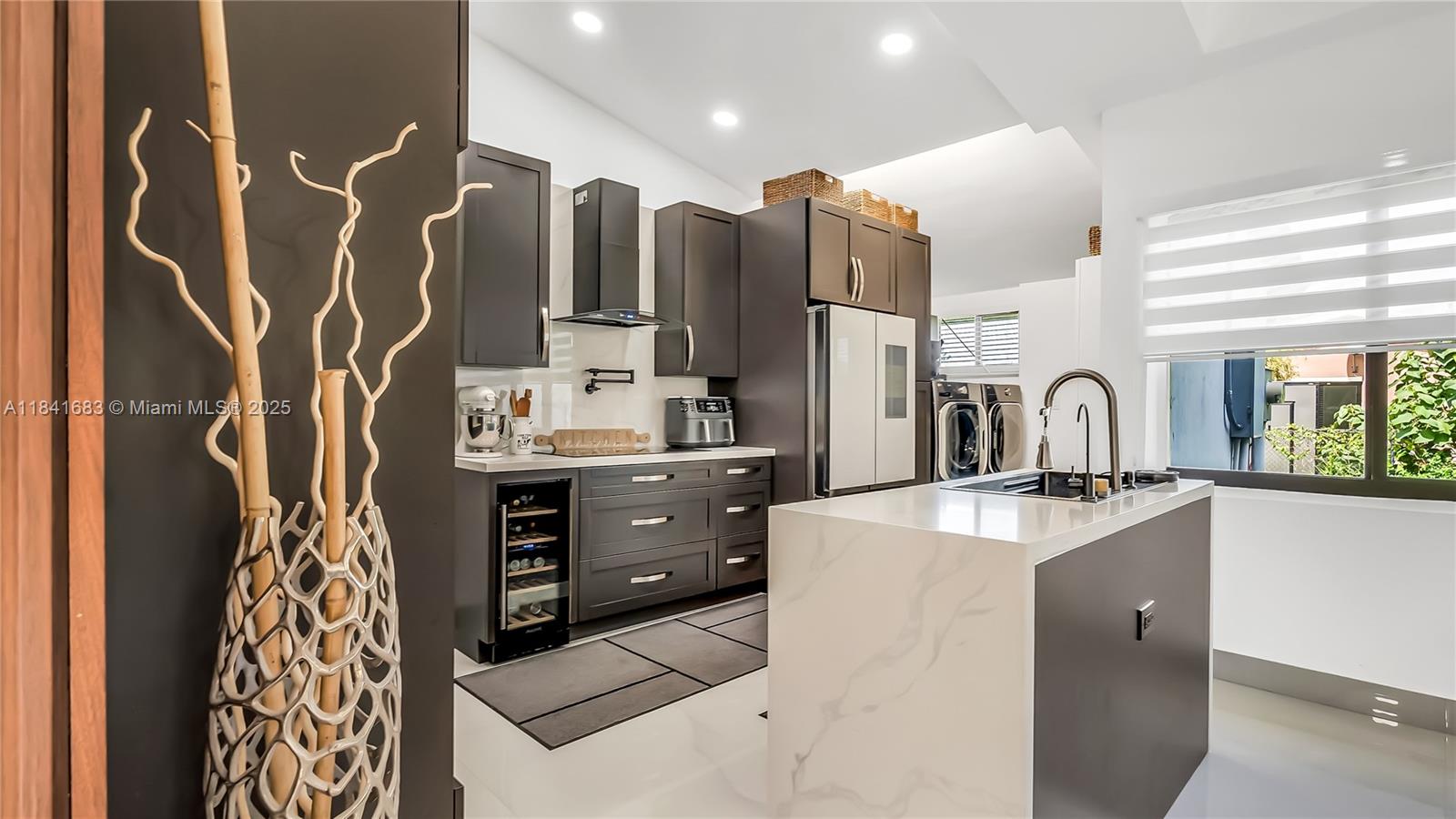 17101 Southwest 48th Street Southwest Ranches, FL 33331 - Photo 36 of 40 a kitchen with stainless steel appliances kitchen island granite countertop a refrigerator and a sink