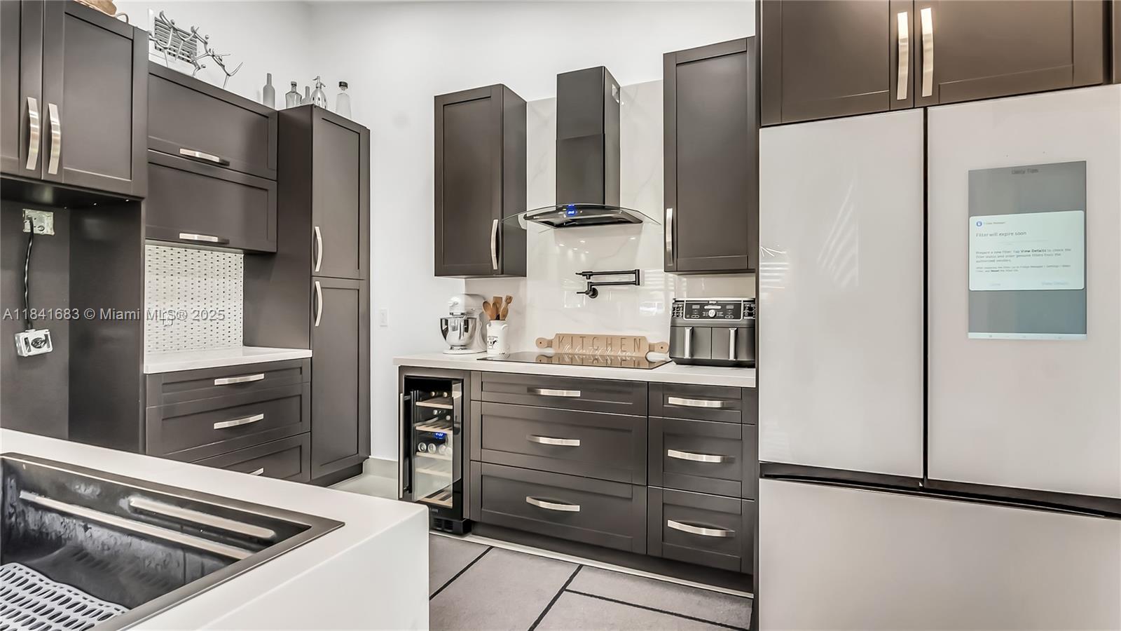 17101 Southwest 48th Street Southwest Ranches, FL 33331 - Photo 37 of 40 a kitchen with stainless steel appliances a refrigerator and a stove top oven