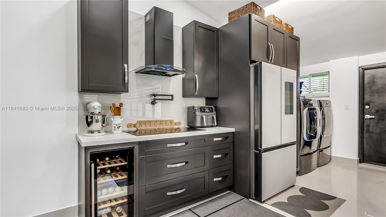 17101 Southwest 48th Street Southwest Ranches, FL 33331 - Photo 39 of 40 a kitchen with stainless steel appliances a refrigerator and a sink
