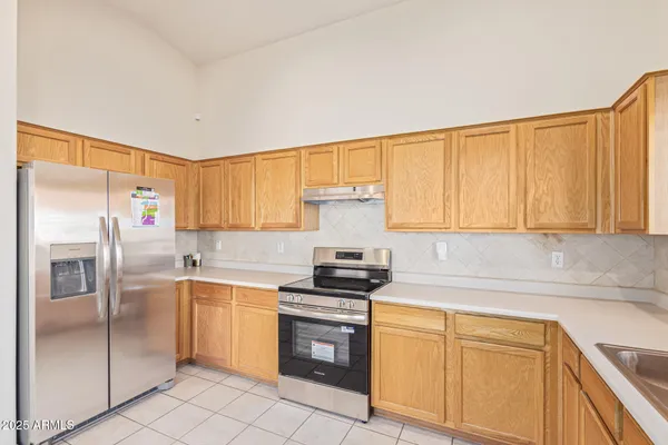 a kitchen with a sink stove and refrigerator