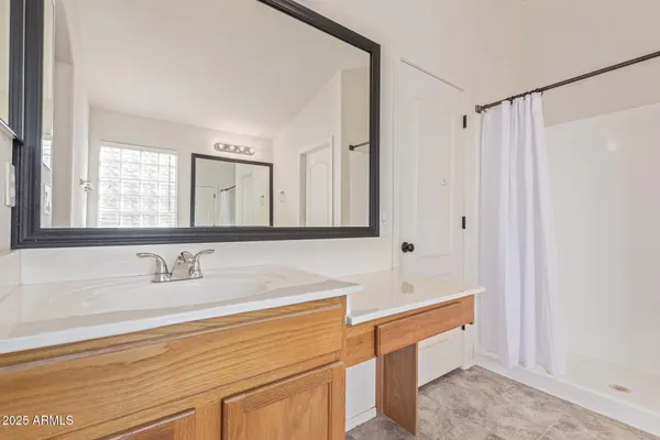 a bathroom with double vanity sink and a mirror