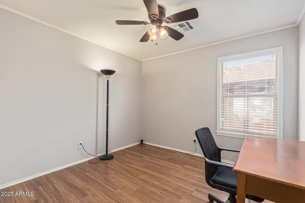 a view of a workspace with furniture and a window