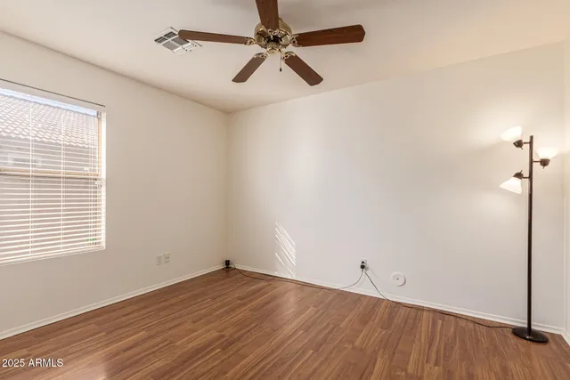 a view of an empty room and wooden floor