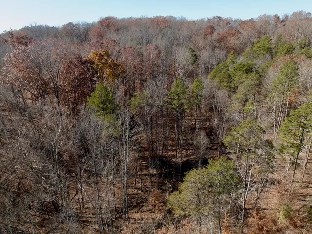 a view of mountain with sunset in background