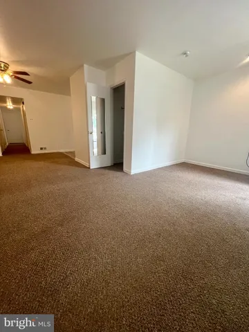 an empty room with a empty space and a ceiling fan