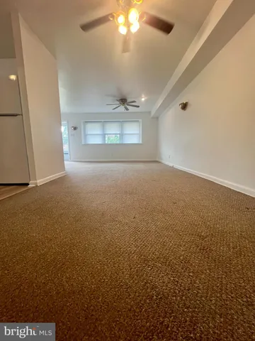 an empty room with a empty space and windows