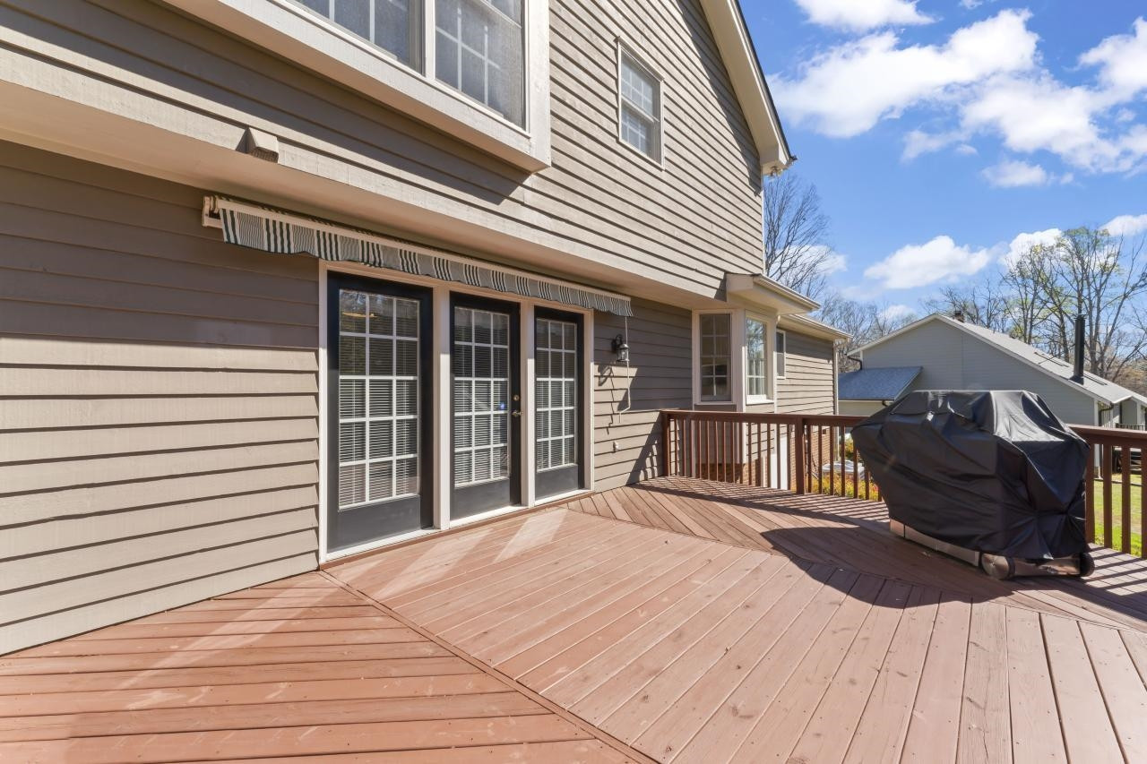 5013 Trail Ridge Drive Raleigh, NC 27613 - Photo 27 of 32 Beautiful back yard view and privacy from this expansive deck. Unroll the awning on extra sunny days and enjoying grilling via the dedicated gas line. Deck