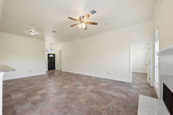 a view of a livingroom with a ceiling fan and window