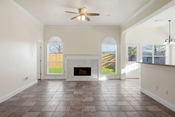 a view of an empty room with a fireplace and a window