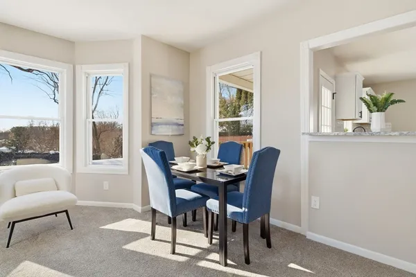 a dining room with furniture and window