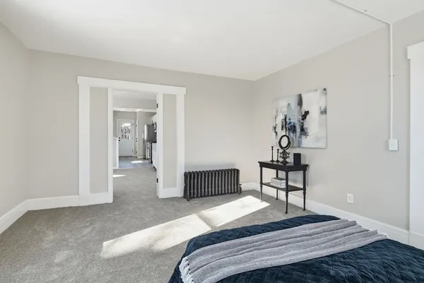 a bedroom with a bed and a table in it