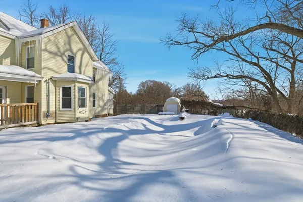 a view of a white house with a yard