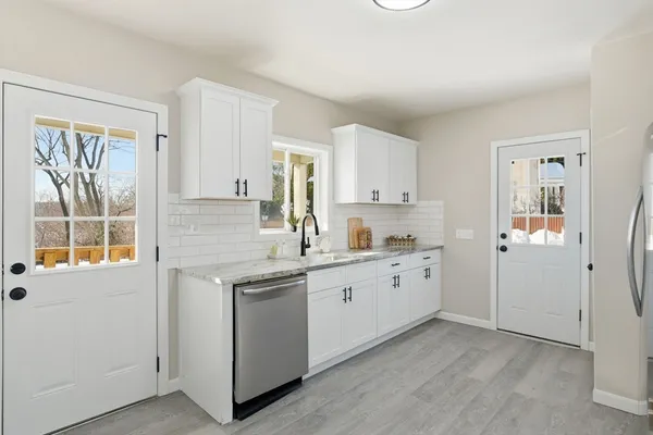 a kitchen with sink cabinets and window