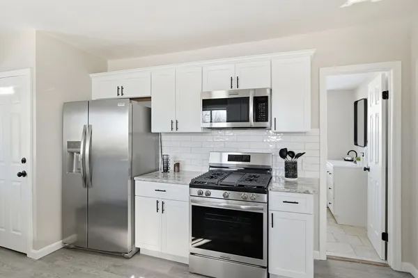 a kitchen with stainless steel appliances a refrigerator stove and microwave
