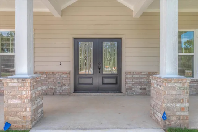a view of front door of house with stairs