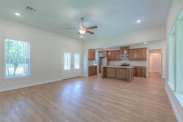 a view of a kitchen with a sink cabinet a kitchen view and wooden floor