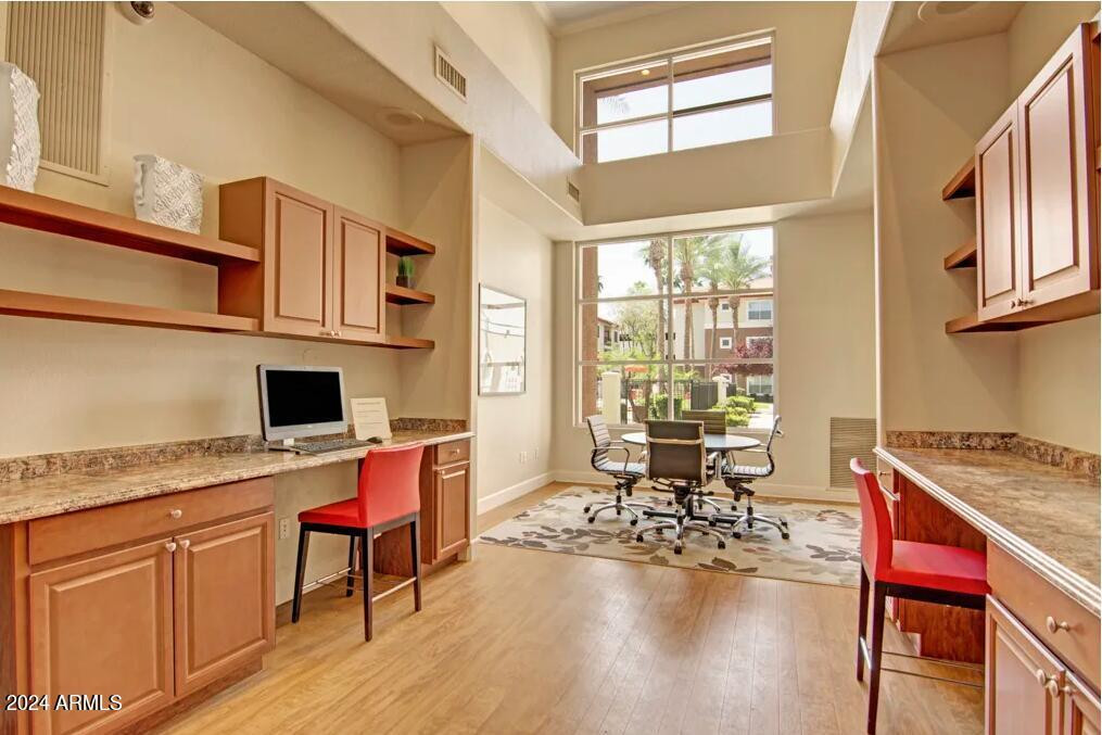 411 East Indian School Road, Unit 21 Phoenix, AZ 85012 - Photo 13 of 16 a work place with granite countertop furniture and a flat screen tv