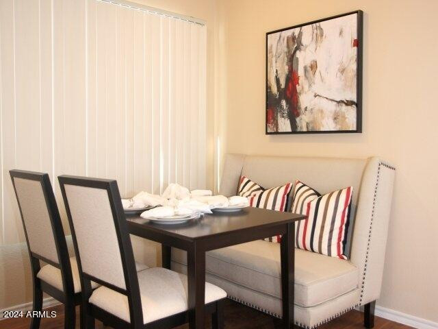 411 East Indian School Road, Unit 21 Phoenix, AZ 85012 - Photo 4 of 16 a view of a dining room with furniture and wooden floor