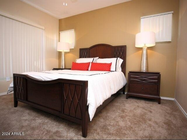 411 East Indian School Road, Unit 21 Phoenix, AZ 85012 - Photo 5 of 16 a bedroom with a bed and a lamp