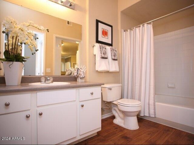 411 East Indian School Road, Unit 21 Phoenix, AZ 85012 - Photo 9 of 16 a bathroom with a sink toilet a mirror and vanity