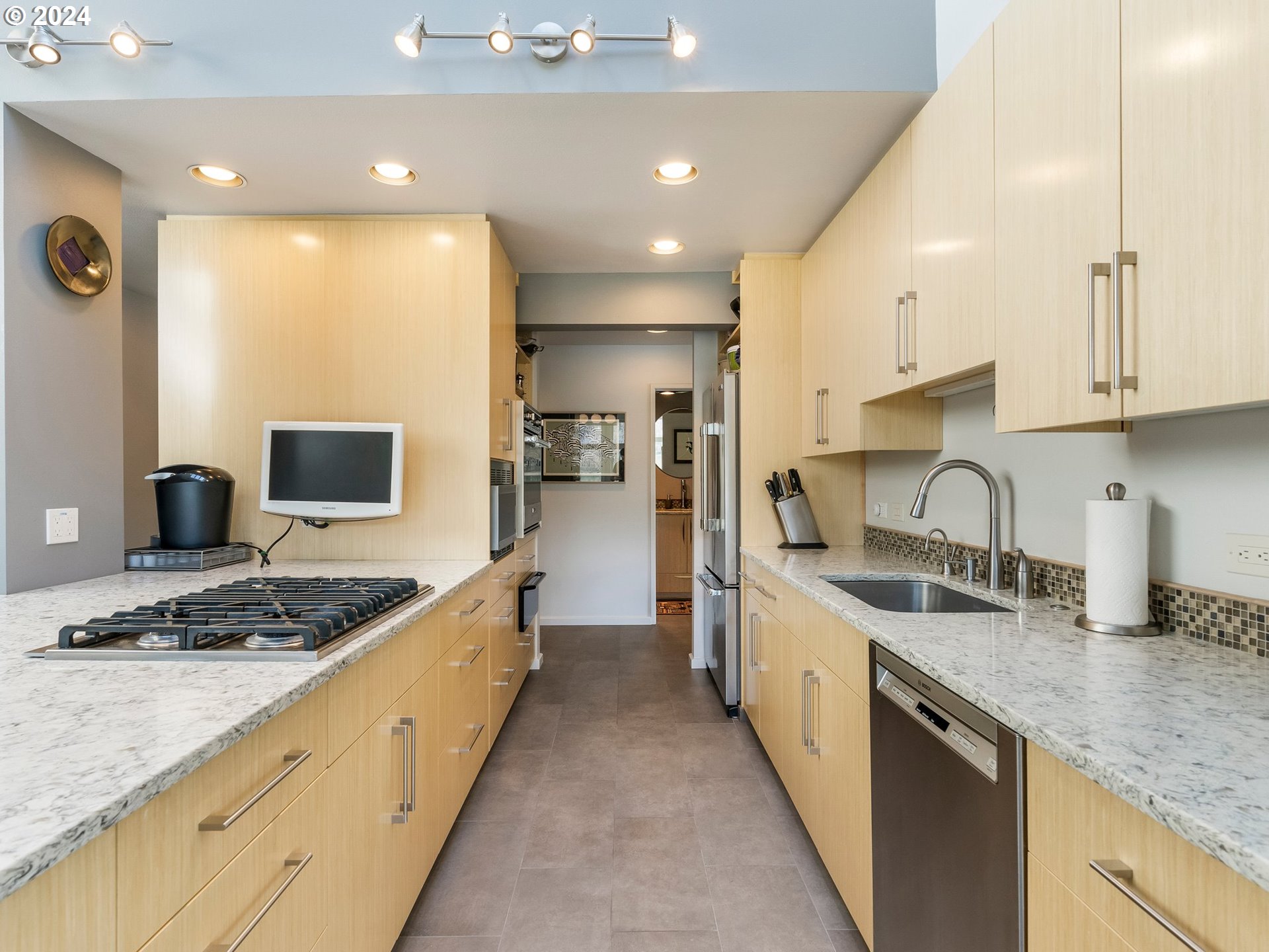 222 Southeast Spokane Street, Unit 3 Portland, OR 97202 - Photo 8 of 47 a large kitchen with stainless steel appliances granite countertop a sink stove and cabinets