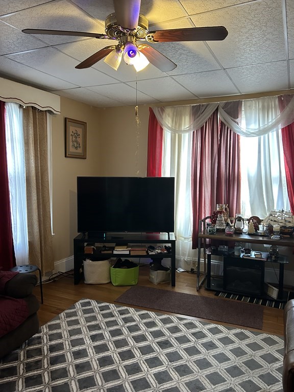 61 Forest Street Boston, MA 02119 - Photo 12 of 36 a room with furniture and a flat screen tv