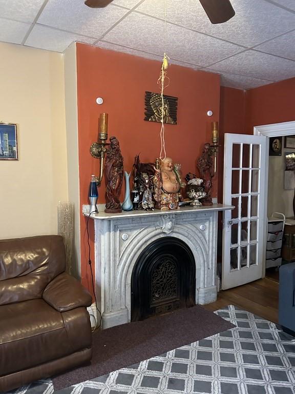 61 Forest Street Boston, MA 02119 - Photo 13 of 36 a living room with furniture a fireplace and a rug