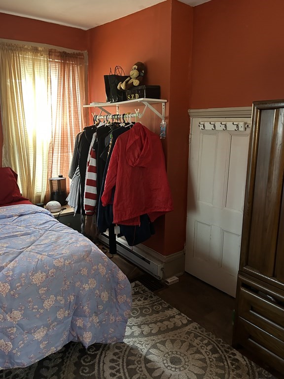 61 Forest Street Boston, MA 02119 - Photo 19 of 36 a bed sitting in a bedroom next to a window