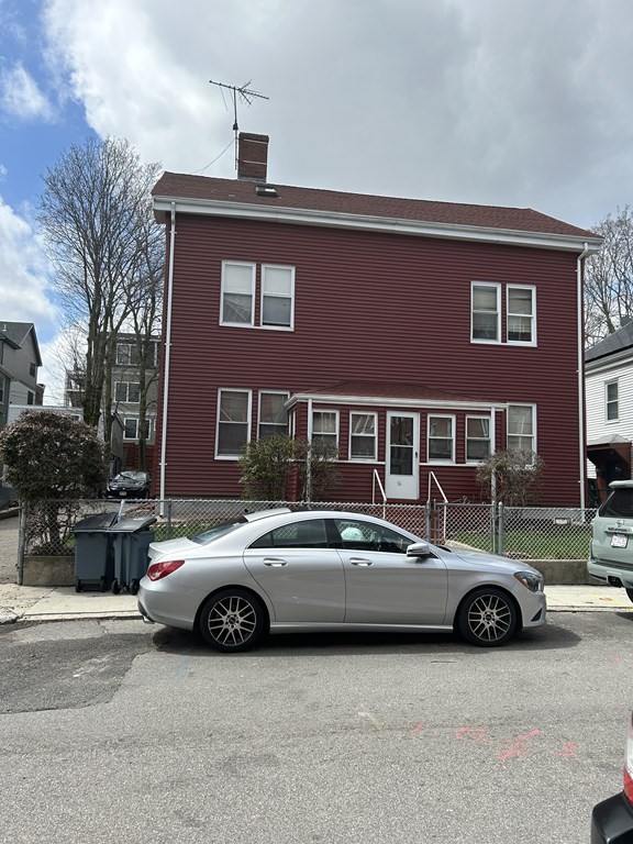 61 Forest Street Boston, MA 02119 - Photo 2 of 36 a car parked in front of a house