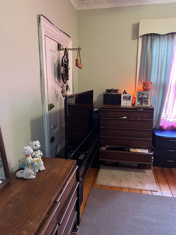 61 Forest Street Boston, MA 02119 - Photo 25 of 36 a bed room with furniture and wooden floor