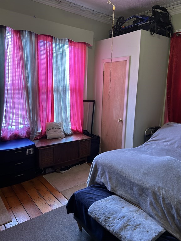 61 Forest Street Boston, MA 02119 - Photo 26 of 36 a bedroom with a bed and window