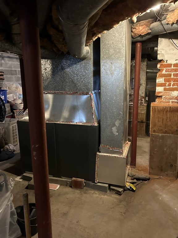 61 Forest Street Boston, MA 02119 - Photo 32 of 36 a room with water heater and a cabinet