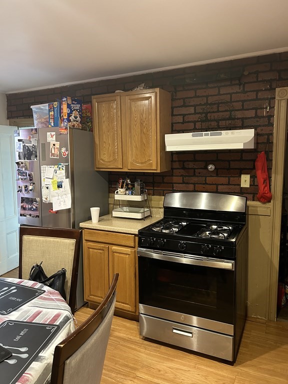 61 Forest Street Boston, MA 02119 - Photo 10 of 36 a kitchen with a stove and white cabinets
