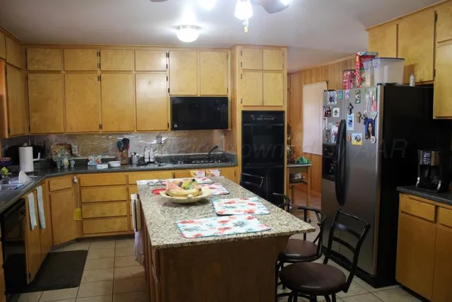 a kitchen with refrigerator and cabinets