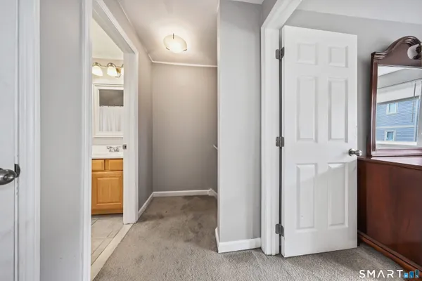 a view of a hallway with wooden shelves