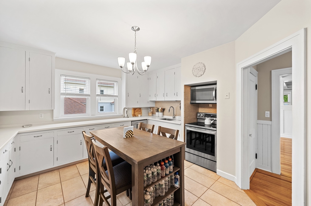 23 Devens Road Worcester, MA 01606 - Photo 16 of 42 a open kitchen with a table and chairs in it