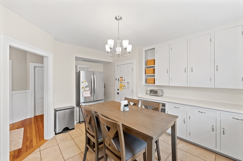 23 Devens Road Worcester, MA 01606 - Photo 17 of 42 a kitchen with a table chairs refrigerator and cabinets
