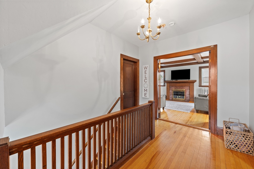23 Devens Road Worcester, MA 01606 - Photo 19 of 42 a view of a hallway view with wooden floor and staircase