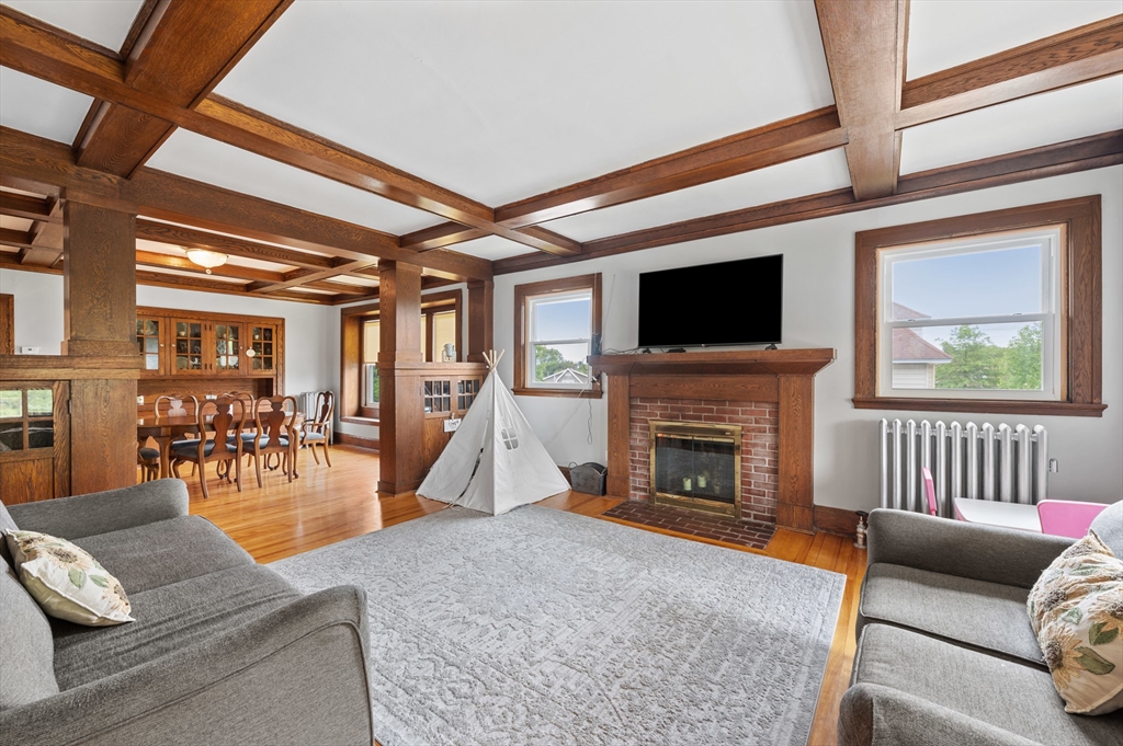 23 Devens Road Worcester, MA 01606 - Photo 20 of 42 a living room with furniture a fireplace and a flat screen tv