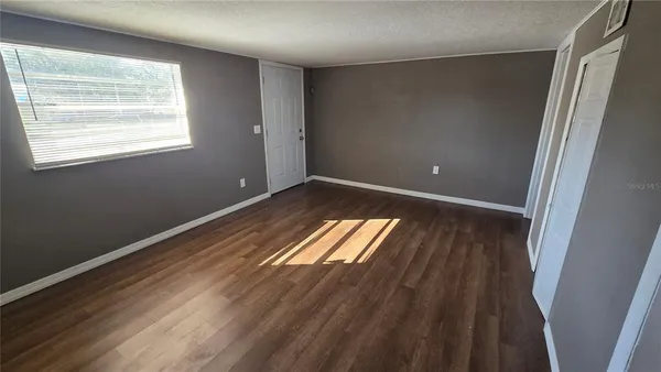 a view of wooden floor and windows in a room
