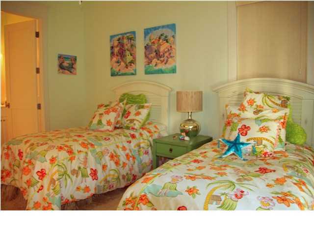 42 Founders Lane Watersound, FL 32461 - Photo 16 of 33 a bedroom with two bed and painting on the wall