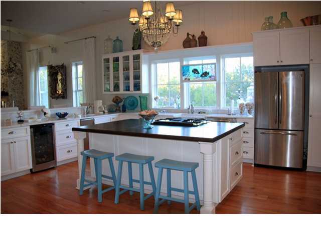 42 Founders Lane Watersound, FL 32461 - Photo 10 of 33 a kitchen with stainless steel appliances granite countertop a stove refrigerator a dining table and chairs