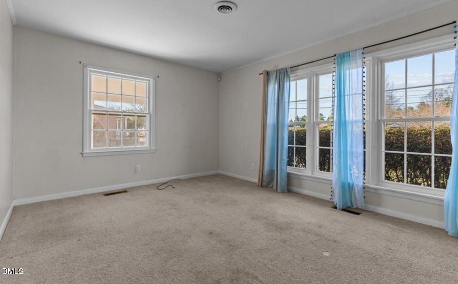 414 York Road Fayetteville, NC 28303 - Photo 5 of 14 an empty room with a fireplace and large windows