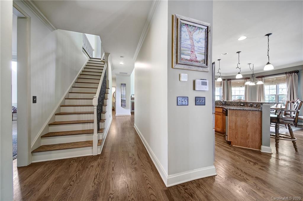 305 Golfview Crest Tega Cay, SC 29708 - Photo 22 of 48 a view of a hallway with wooden floor and staircase