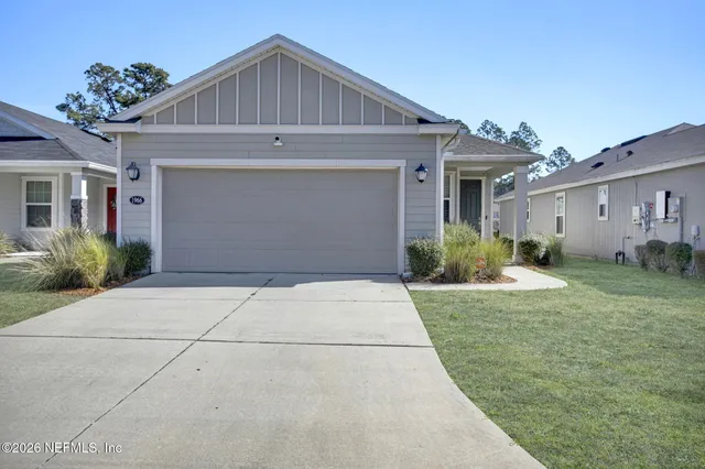 a front view of house with garage and yard