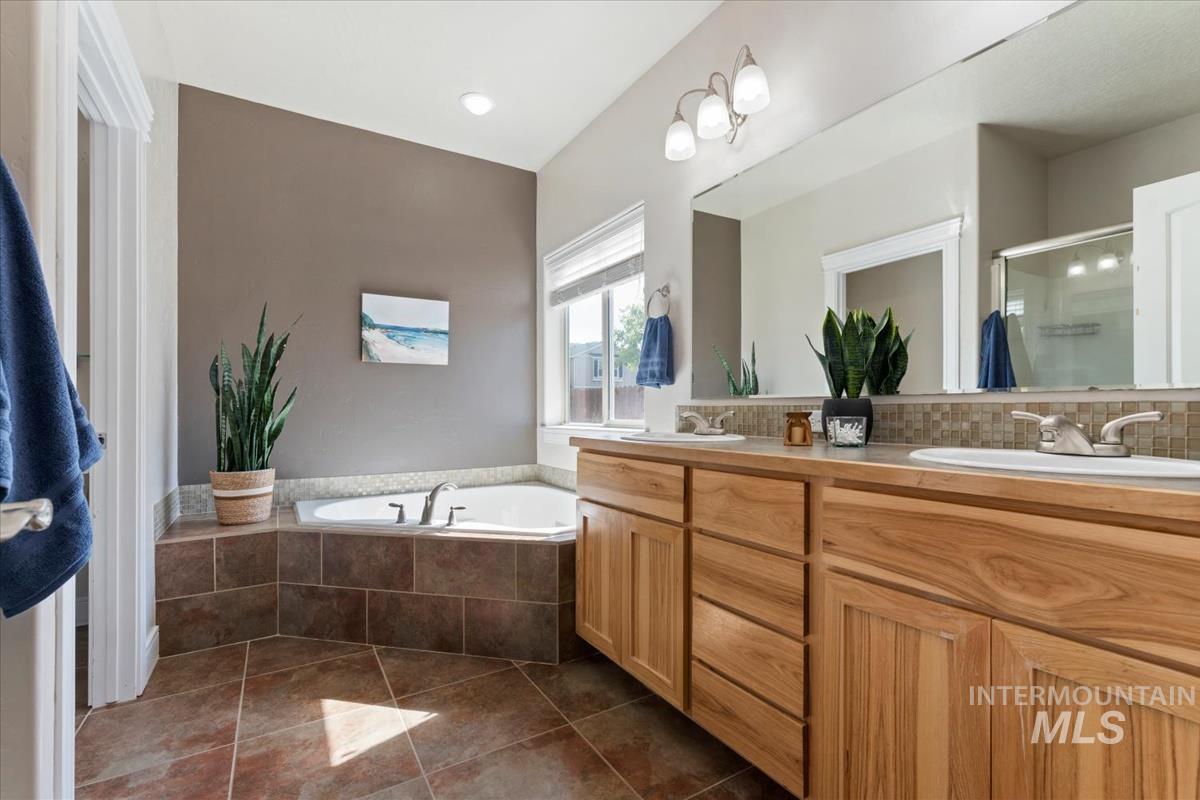640 Southwest Miner Street Mountain Home, ID 83647 - Photo 21 of 35 Dual vanity with wood-finish cabinetry and integrated sinks