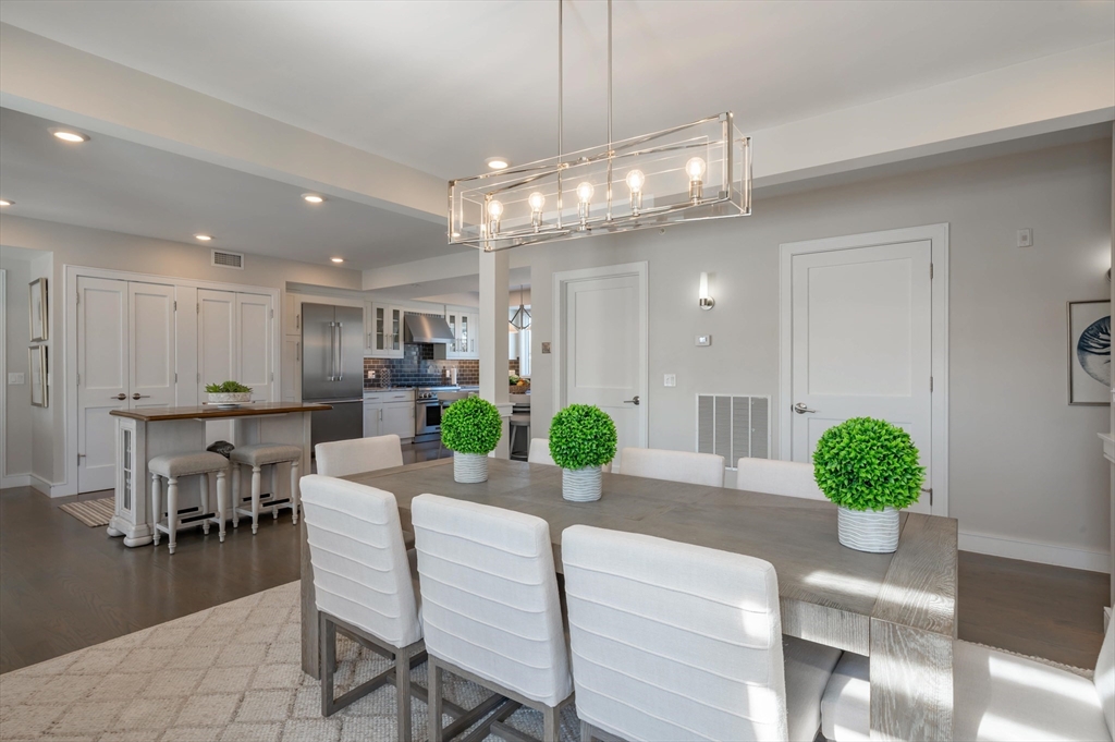 78 Thatcher Road, Unit 6 Gloucester, MA 01930 - Photo 14 of 41 a view of a dining room with furniture a chandelier and wooden floor