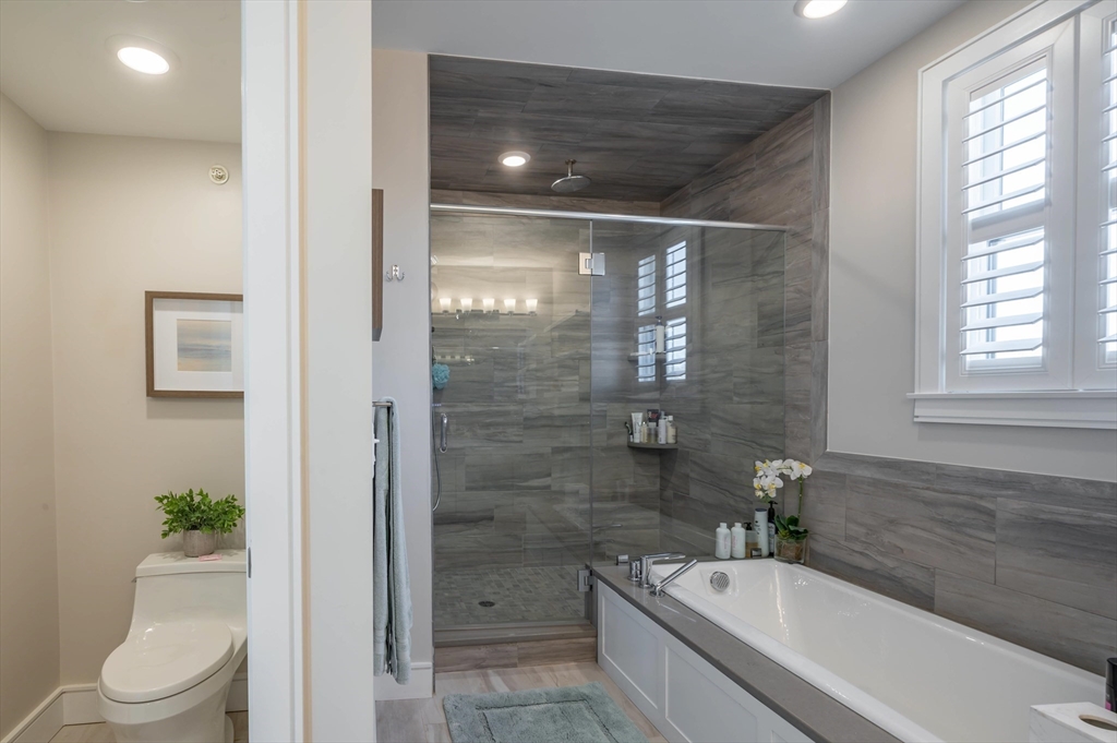 78 Thatcher Road, Unit 6 Gloucester, MA 01930 - Photo 20 of 41 a bathroom with a granite countertop bathtub shower sink mirror and toilet