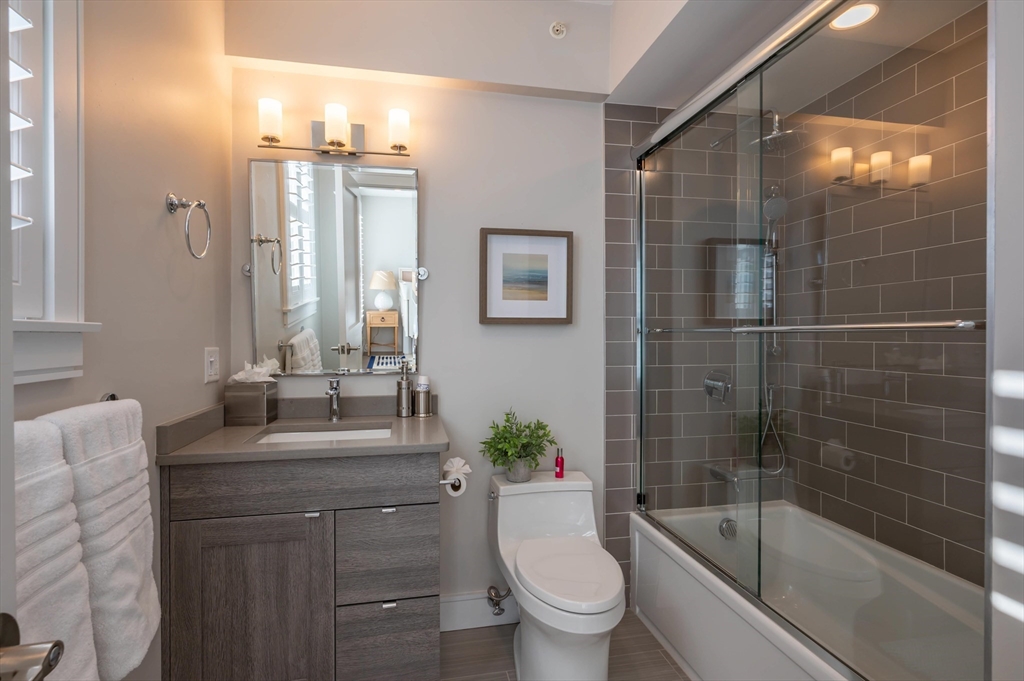 78 Thatcher Road, Unit 6 Gloucester, MA 01930 - Photo 23 of 41 a bathroom with a bathtub shower sink vanity and toilet